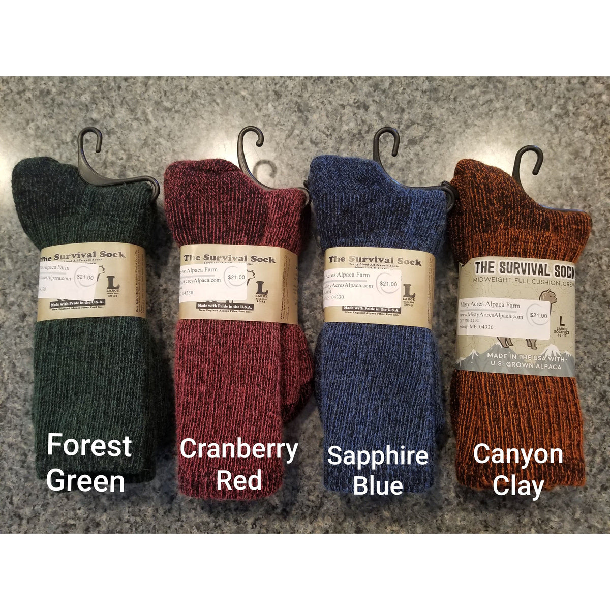 Photo of 4 colors of alpaca survival sock in forest green, cranberry red, sapphire blue, and canyon clay