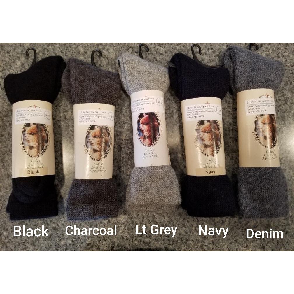 Photo of 6 socks in black, charcoal, lt grey, navy and denim wrapped in retail packaging/stickers