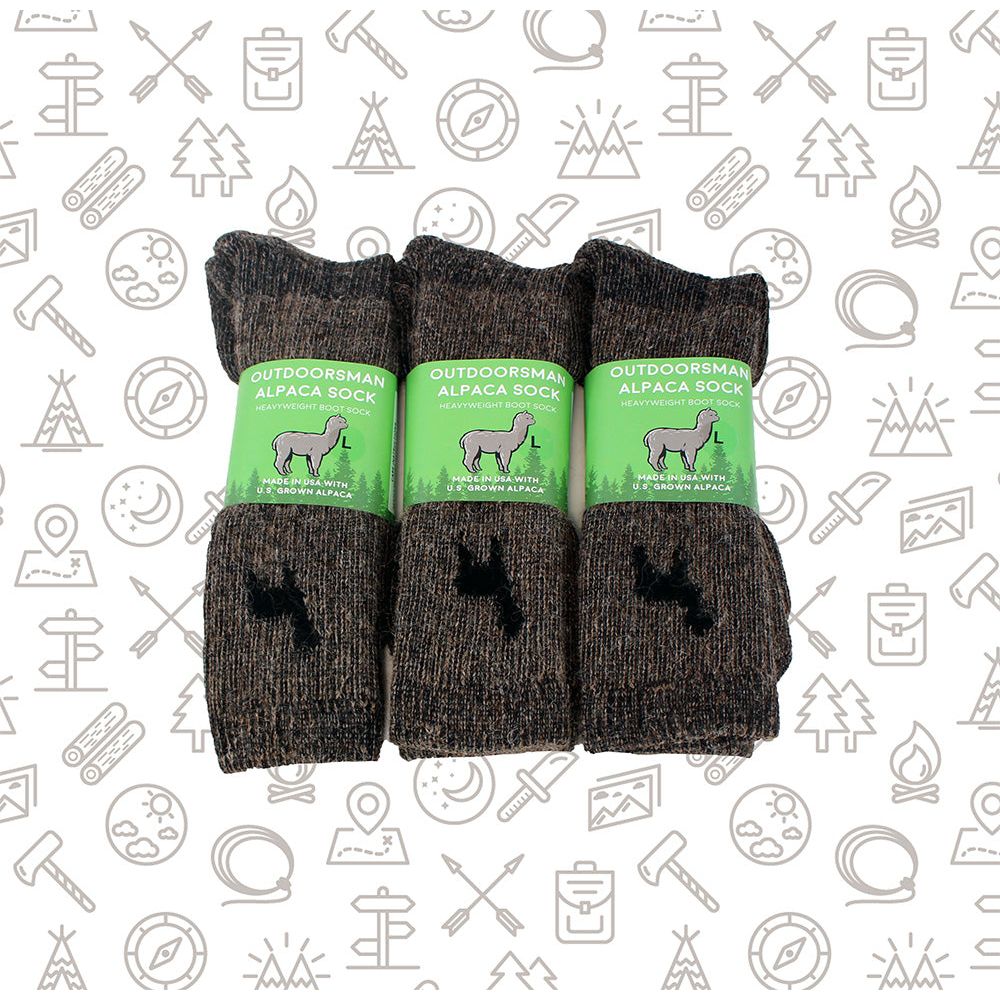 Photo of 3 alpaca socks in retail packaging on a white background